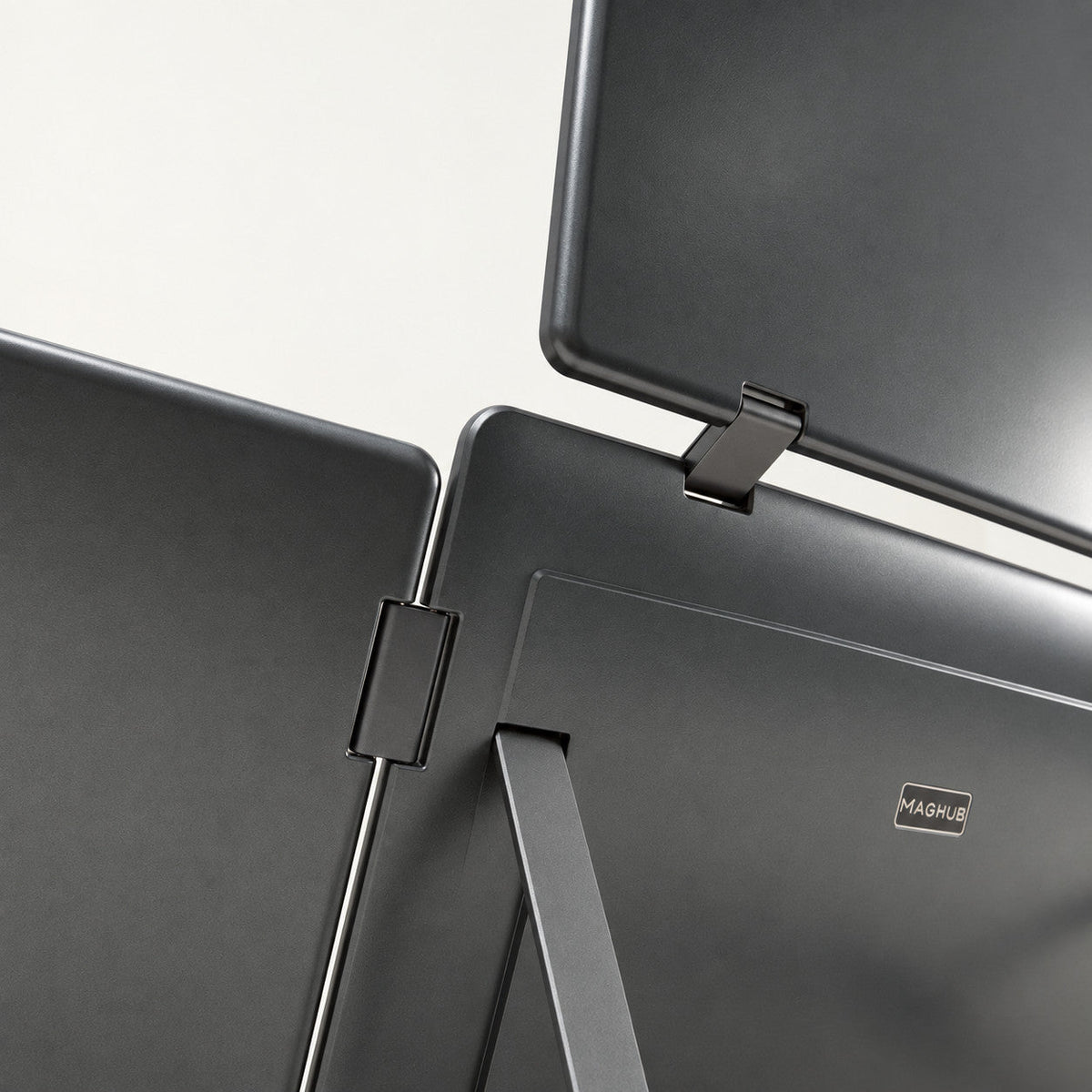 Close-up rear view of the MagHub Quad Max screen extender, showing the upper and side display hinges, MagHub logo and support stand.