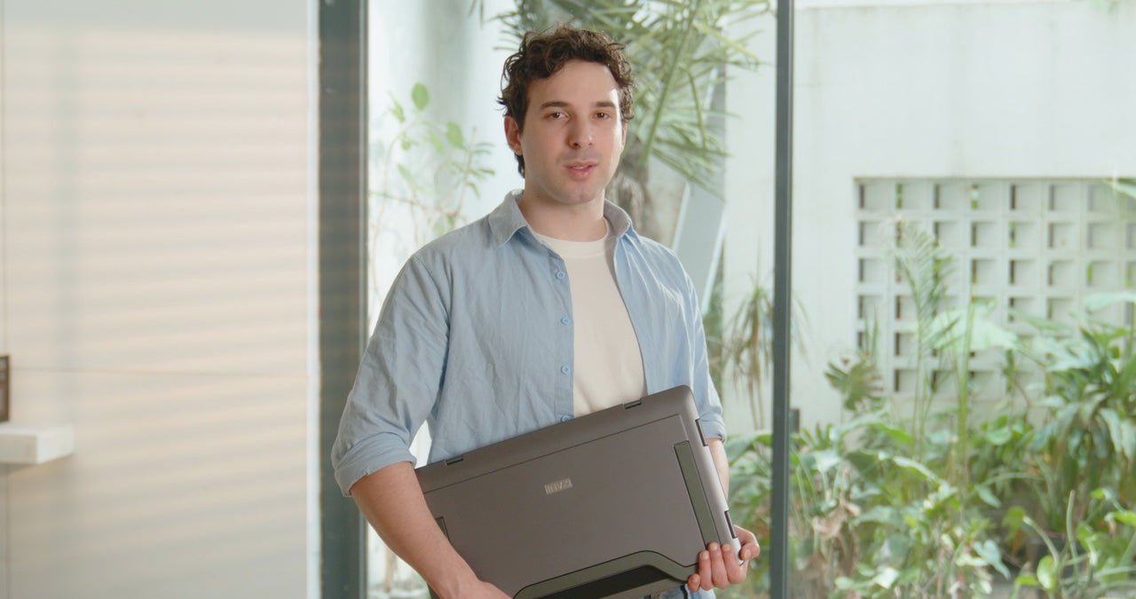 Professional carrying a folded MagHub Quad Max display system